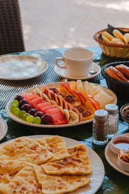 a table with plates of food on top at Hôtel Dar 55 - Berber House - Boutique Hôtel in Marrakech