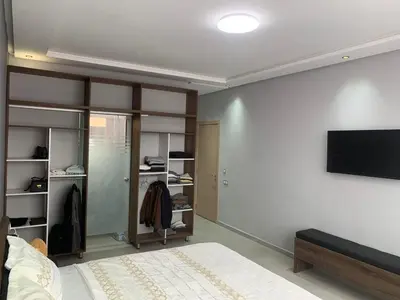 a bedroom with a bed and a flat screen tv at Riad L'Aéroport in Marrakech