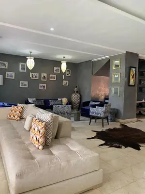 a large living room with a white couch and a living room with a couch at Villa Firdaous in Marrakech