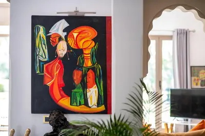 a painting of colorful bottles on a wall in a living room at Villa Cartier in Marrakech