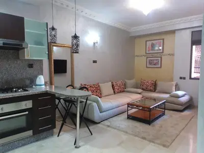 a living room with a couch and a table at Central Aparts Av Prince Moulay Abdellah in Marrakech