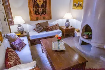 a living room with a couch and a table at Riad Dar Talah in Marrakech