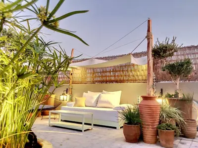 a white couch on a patio with plants at Riad Dar Chacha in Marrakech