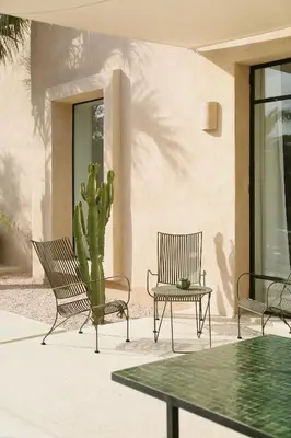 a group of chairs and a cactus on a patio at Villa Dar Challa in Marrakech