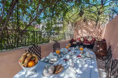 a table with a bowl of fruit on top at Room in BB - Riad Anabel - Chocolat Double Room in Marrakech