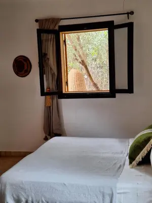 a bedroom with a bed and a window at Beldicolors in Marrakech