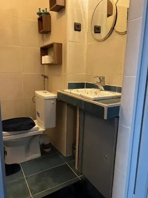 a bathroom with a toilet and a sink and a mirror at Riad Dar Chadia in Marrakech