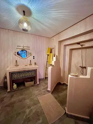a room with a fireplace and a tv on the ceiling at Riad Dar Chadia in Marrakech