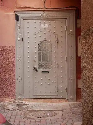 a metal door with a window on a building at Riad Dar Chadia in Marrakech