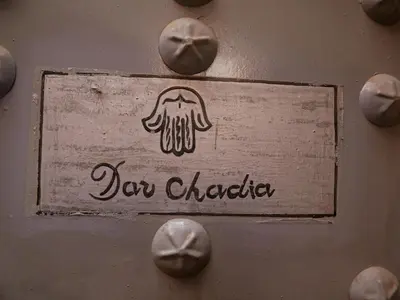 a sign on a wall with a drawing of a dog character at Riad Dar Chadia in Marrakech