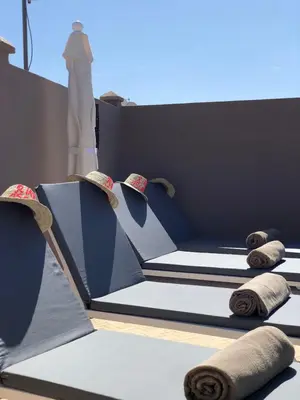 a couple of beds sitting on top of a building at Riad Oscaroi in Marrakech
