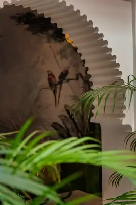 a mirror with a painting of a bird on it at Riad Le Saadien ,Adult only in Marrakech