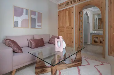 a living room with a couch and a glass table at Riad Le Saadien ,Adult only in Marrakech