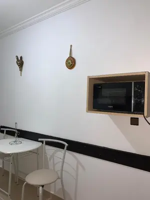a table and chairs and a microwave on a wall at diamant Marrakech centre in Marrakech