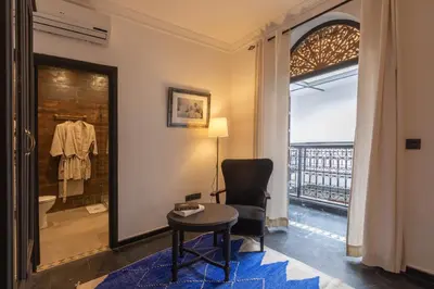 a room with a table and a chair and a window at Riad Ksar Saad & Spa in Marrakech