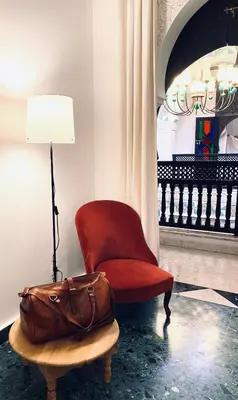 a bag sitting next to a chair and a lamp at Riad Ksar Saad & Spa in Marrakech