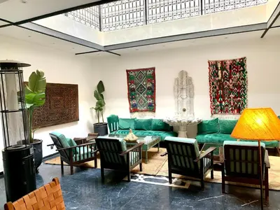 a living room with a green couch and chairs at Riad Ksar Saad & Spa in Marrakech