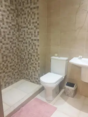 a bathroom with a toilet and a sink at Apparemment yasmina in Marrakech