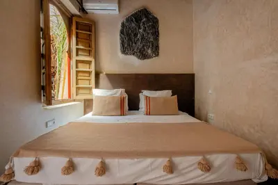 a bedroom with a large bed in a room at Riad Tassili Marrakech in Marrakech