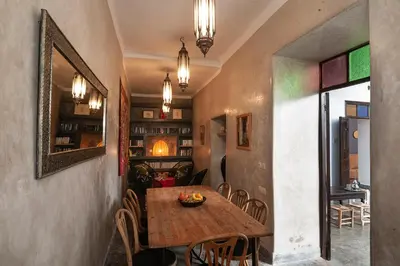 a dining room with a wooden table and chairs at Dar Le Fennec in Marrakech