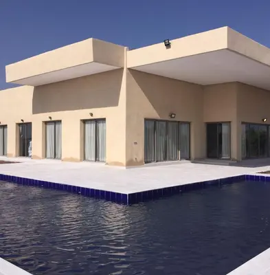 a building with water in front of it at Villa Jamila -Villa de luxe a Marrakech in Marrakech