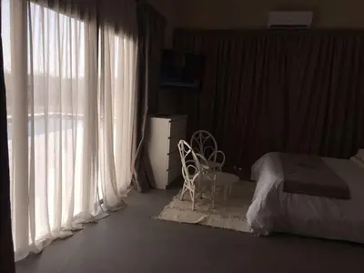 a bedroom with a bed and a window with curtains at Villa Jamila -Villa de luxe a Marrakech in Marrakech