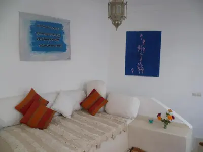 a living room with a white couch with pillows at Dar Daoud in Marrakech