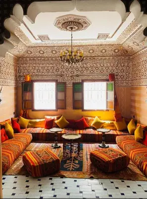 a living room with couches and a chandelier at Hostel Essassi 23 in Marrakech