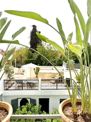 a house with two potted plants on a fence at RIAD MAGIE Boutique Hotel in Marrakech