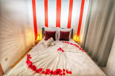 a bedroom with a bed with red roses on it at Riad Amirkesh and Pool in Marrakech