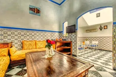 a living room with a couch and a table at Riad Amirkesh and Pool in Marrakech
