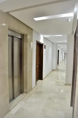 an empty hallway of a building with doors and tile floors at Royal Deluxe Gold - Marrakech, Luxe Pool View in Marrakech