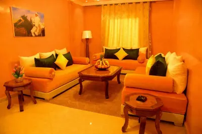 a living room with two couches and a table at Hôtel La Citta Rossa in Marrakech