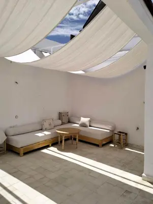 a living room with a couch and a table at Riad Siena II in Marrakech