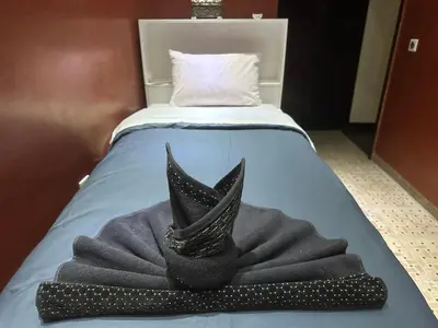 a bed with a black hat and a black bow tie at Riad luna in Marrakech
