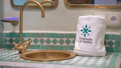a towel sitting on a counter next to a sink at L'Emeraude de la Médina in Marrakech