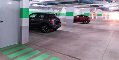 a parking garage with two cars parked in it at Royal Deluxe Silver - Marrakech, Luxe Pool View in Marrakech