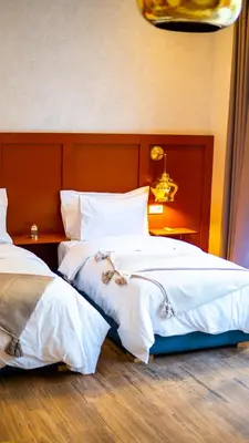 two beds sitting next to each other in a room at Riad villa saphir & SPA in Marrakech
