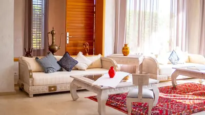 a living room with a couch and a table at Riad villa saphir & SPA in Marrakech