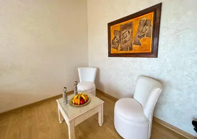 a room with two chairs and a table with a bowl of fruit at Riad villa saphir & SPA in Marrakech