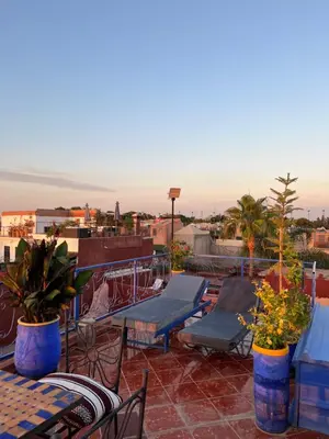 a patio with tables and chairs on a roof at Appartment Khadija in Marrakech