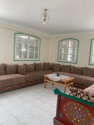 a living room with couches and a coffee table at APPARTEMENT PERLE RARE AU CENTRE DE MARRAKECH in Marrakech