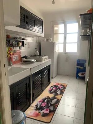 a kitchen with a counter with a towel on the floor at APPARTEMENT PERLE RARE AU CENTRE DE MARRAKECH in Marrakech
