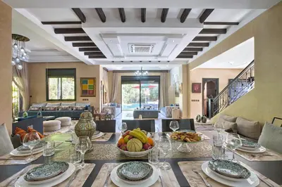a dining room with a table with a bowl of fruit at VILLA Garden in Marrakech