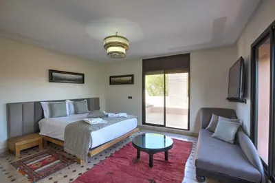 a bedroom with a bed and a couch at VILLA Garden in Marrakech