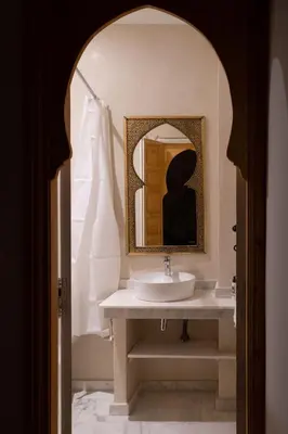 a bathroom with a sink and a mirror at Riad El Habib in Marrakech
