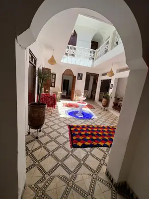 an archway leading into a living room with a rug at Riad Malfa in Marrakech