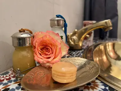 a bathroom counter with a plate and a rose and a sink at Riad Malfa in Marrakech