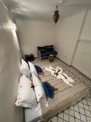 a room with a bed with pillows on it at Riad Malfa in Marrakech