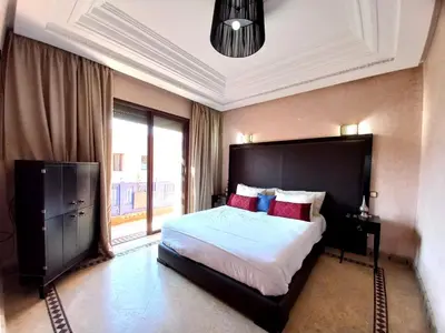 a bedroom with a large bed and a large window at SABOR VILLA TARGA GARDEN -Only Family in Marrakech